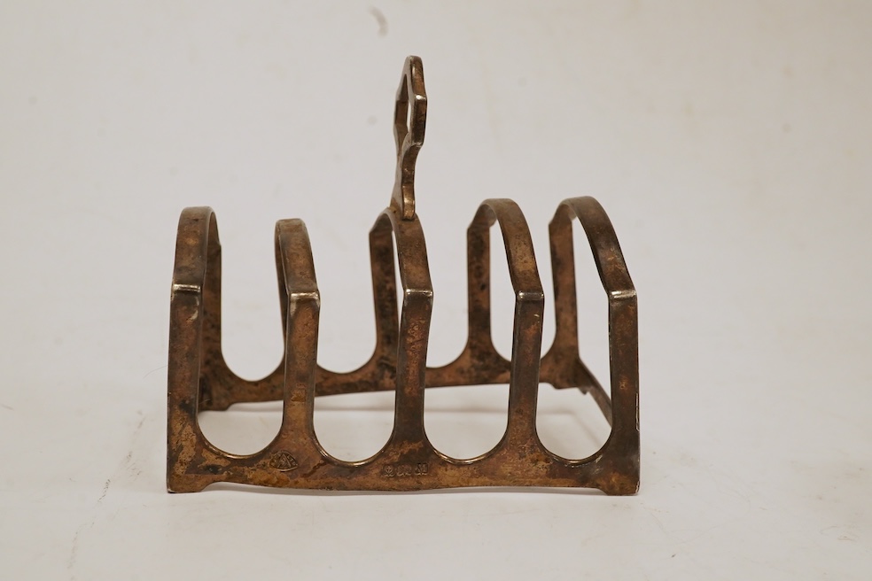 Two cased sets of six silver bean end coffee spoons, a Victorian silver bun salt, three assorted silver napkin rings, a small silver five bar toast rack and a sterling pen. Condition - poor to fair